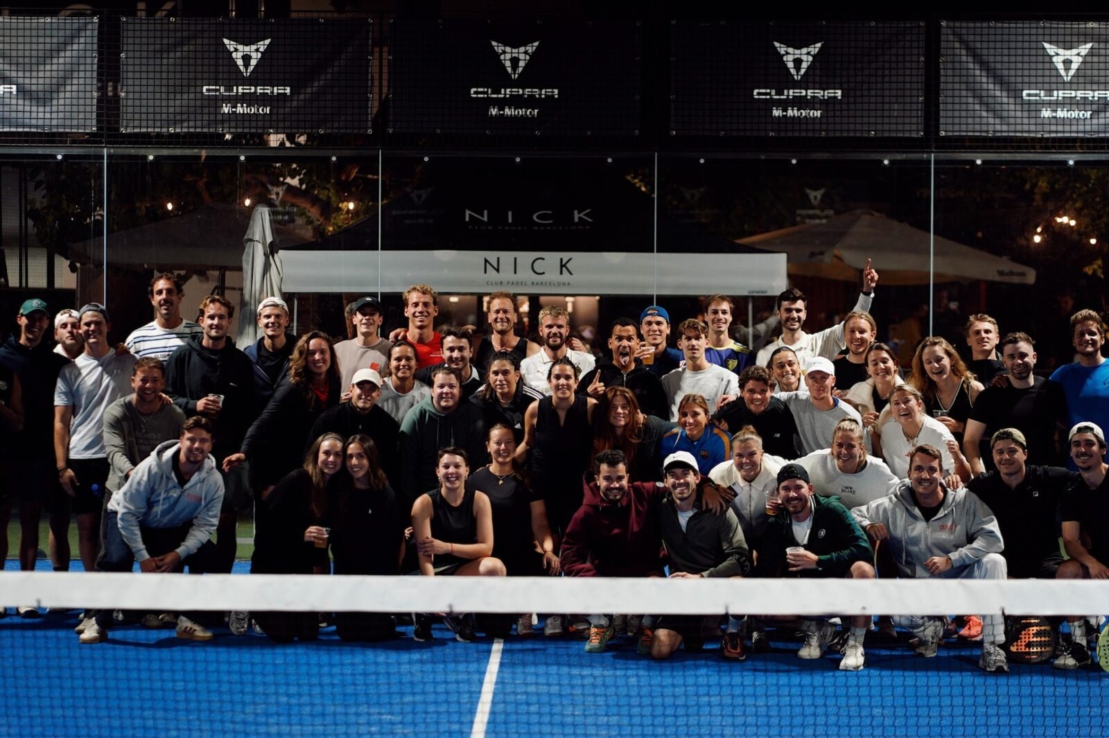 Padel players gathered on a floodlit court after a Voyas Padel Nights tournament